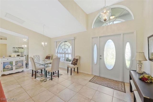 foyer with a chandelier, tile patterned flooring, and baseboards