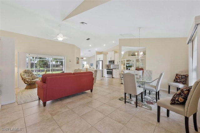 living area with light tile patterned flooring, visible vents, ceiling fan with notable chandelier, and vaulted ceiling