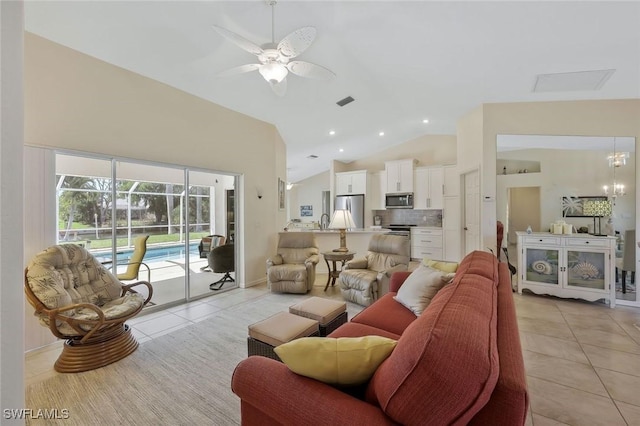 living area featuring high vaulted ceiling, light tile patterned flooring, recessed lighting, a sunroom, and ceiling fan with notable chandelier