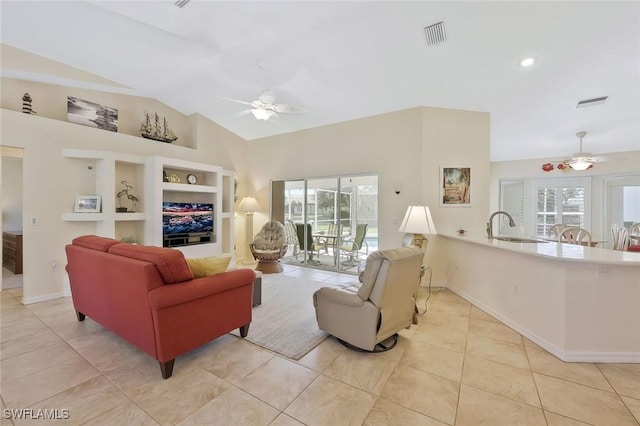 living room featuring lofted ceiling, light tile patterned floors, a healthy amount of sunlight, and ceiling fan