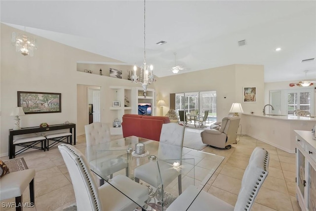 dining room with light tile patterned flooring, visible vents, ceiling fan with notable chandelier, and vaulted ceiling