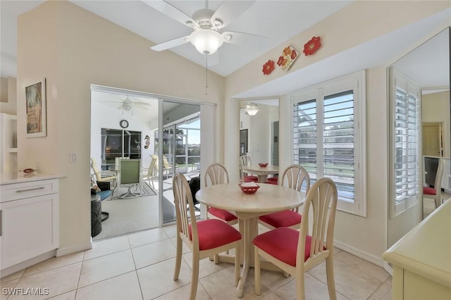 dining room featuring vaulted ceiling, light tile patterned flooring, and ceiling fan