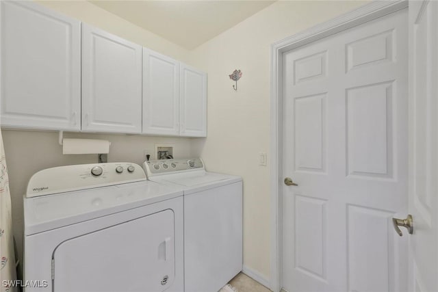 laundry area with cabinet space, washing machine and dryer, and baseboards