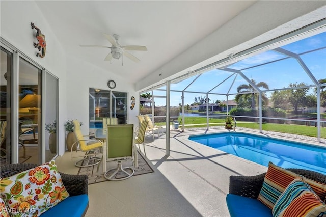 outdoor pool with a patio, a ceiling fan, a water view, and a lanai