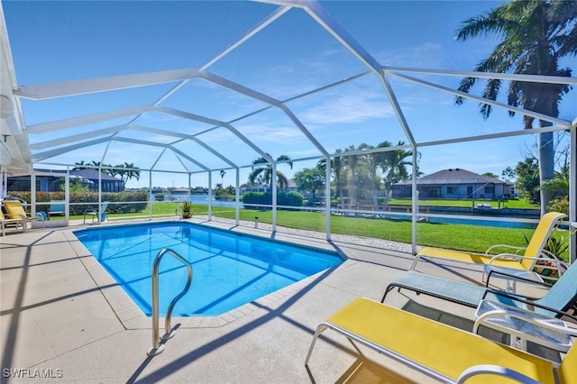 outdoor pool with a yard, a patio, and a lanai