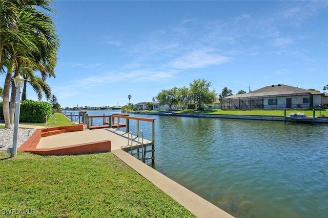 dock area featuring a water view and a lawn