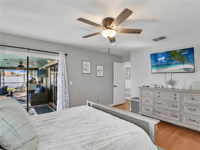 bedroom featuring visible vents, wood finished floors, ceiling fan, and access to outside