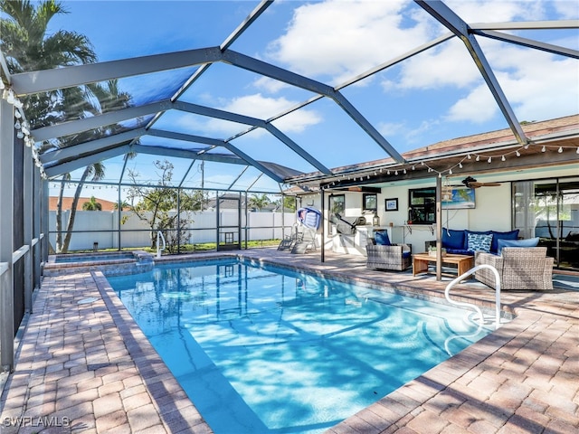 view of pool featuring glass enclosure, a patio, a fenced backyard, and an outdoor living space