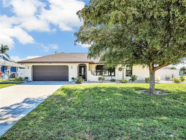 single story home with a front lawn, an attached garage, driveway, and stucco siding