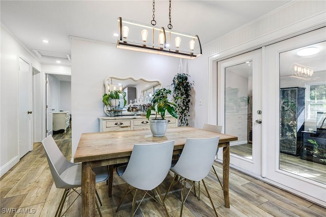 dining room featuring crown molding, recessed lighting, and light wood finished floors