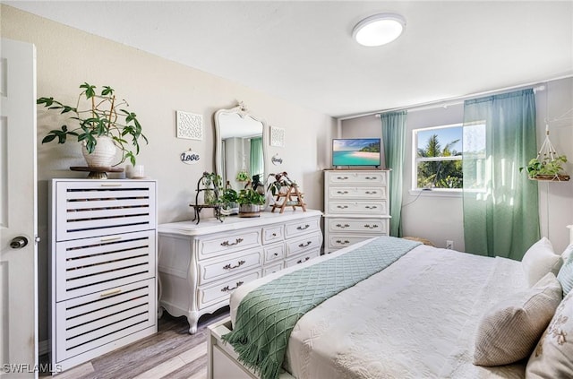 bedroom featuring light wood-style flooring