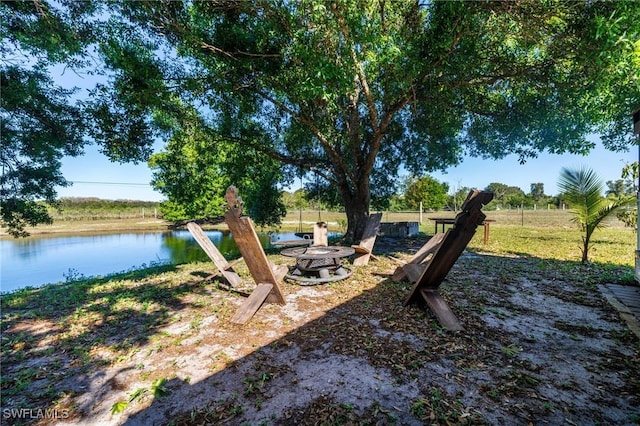 view of yard featuring a fire pit and a water view