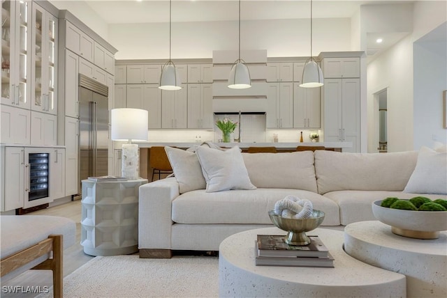 living room with a high ceiling and beverage cooler