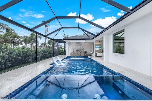 view of swimming pool featuring a lanai, a patio, ceiling fan, and a pool with connected hot tub