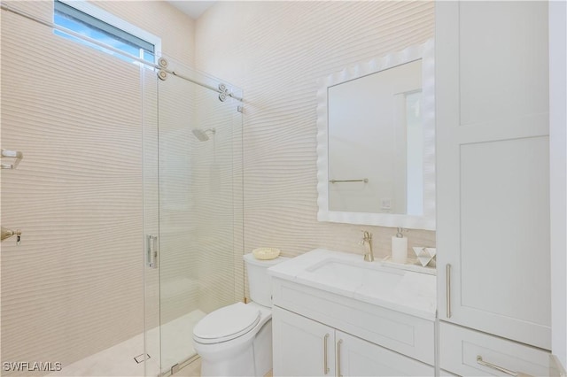 bathroom featuring tile walls, a stall shower, toilet, and vanity