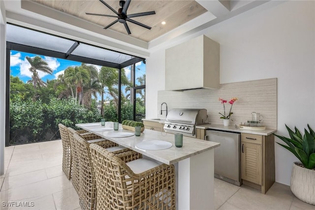 kitchen featuring a sink, fridge, light countertops, decorative backsplash, and a raised ceiling