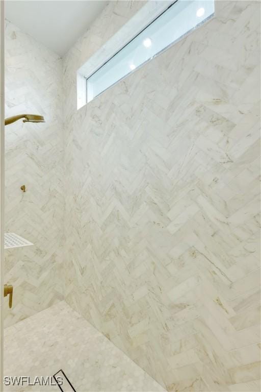 bathroom with a marble finish shower