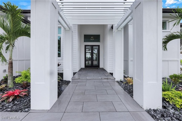 doorway to property with french doors and a pergola