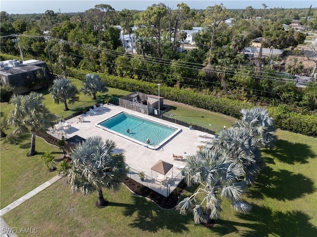 pool with a patio and a lawn