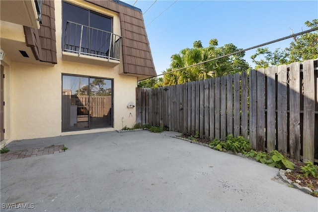 view of patio featuring fence