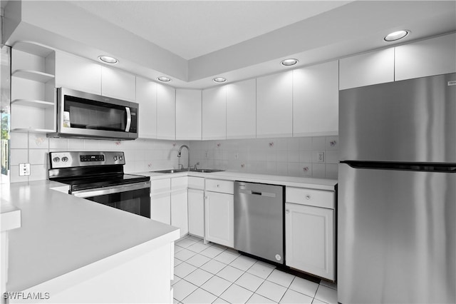 kitchen featuring light countertops, tasteful backsplash, appliances with stainless steel finishes, and a sink