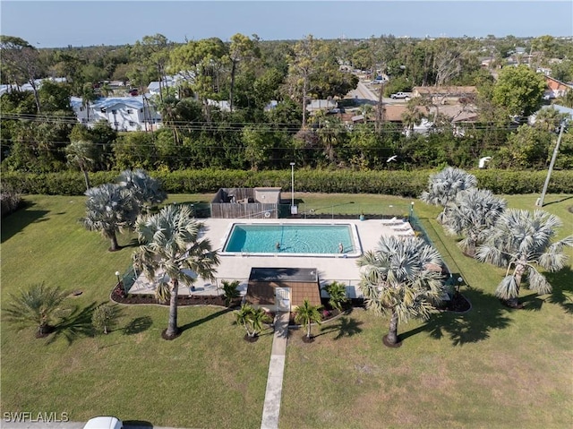 exterior space with a patio area, a lawn, and a fenced in pool