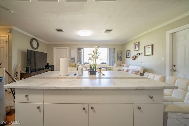 1862 Moreno Ave, Fort Myers, FL 33901 - kitchen featuring visible vents, white cabinetry, open floor plan, and ornamental molding