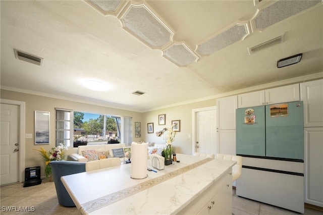 1862 Moreno Ave, Fort Myers, FL 33901 - kitchen with light tile patterned flooring, visible vents, and fridge