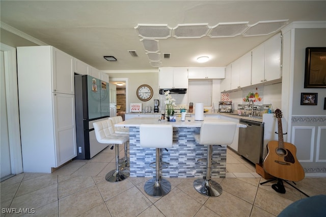 1862 Moreno Ave, Fort Myers, FL 33901 - kitchen with visible vents, light countertops, light tile patterned floors, white cabinets, and stainless steel appliances