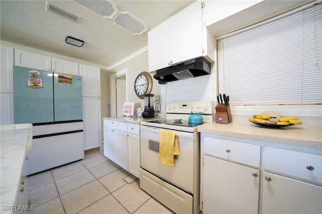 1862 Moreno Ave, Fort Myers, FL 33901 - kitchen with light tile patterned floors, visible vents, freestanding refrigerator, under cabinet range hood, and white electric range