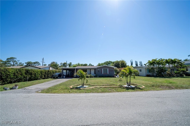1862 Moreno Ave, Fort Myers, FL 33901 - view of front facade featuring a carport, a front lawn, and driveway