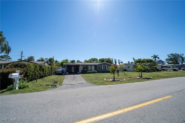 1862 Moreno Ave, Fort Myers, FL 33901 - ranch-style home with a front yard, a carport, and driveway