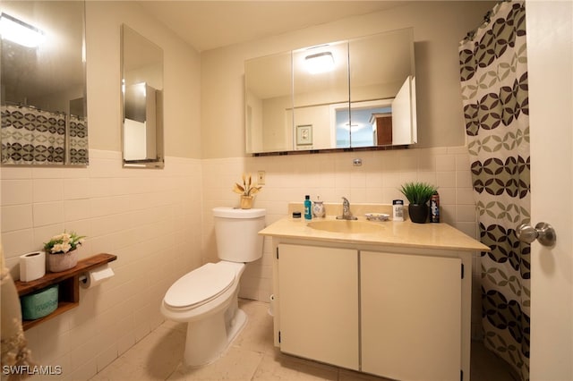 1862 Moreno Ave, Fort Myers, FL 33901 - bathroom with tile walls, a wainscoted wall, toilet, and vanity