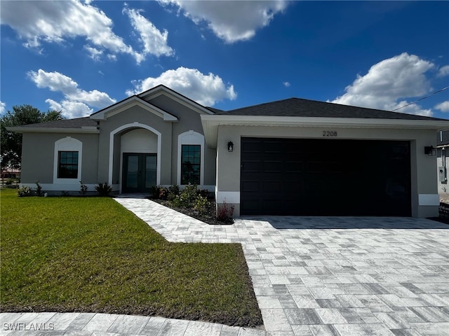 ranch-style house featuring stucco siding, decorative driveway, a front yard, and an attached garage