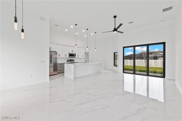 unfurnished living room with crown molding, marble finish floor, a towering ceiling, and ceiling fan