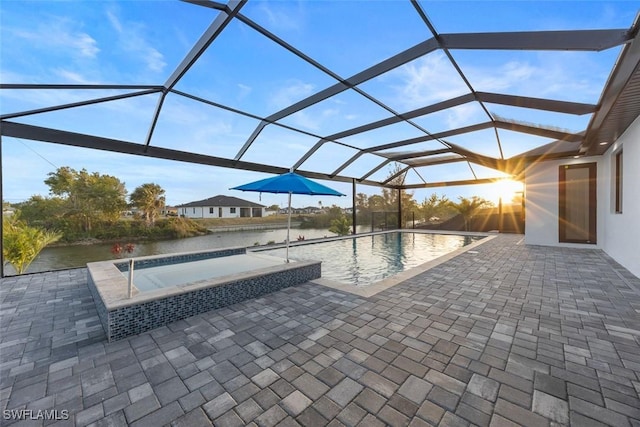 outdoor pool with a patio, an in ground hot tub, a lanai, and a water view