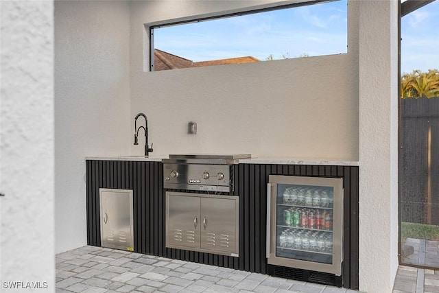 view of patio / terrace with wine cooler and a sink