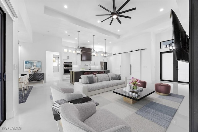 living room featuring recessed lighting, a barn door, and ceiling fan