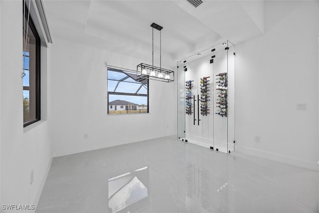 unfurnished dining area featuring visible vents, baseboards, and a chandelier