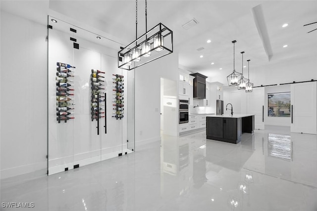 interior space featuring visible vents, recessed lighting, a barn door, and a sink