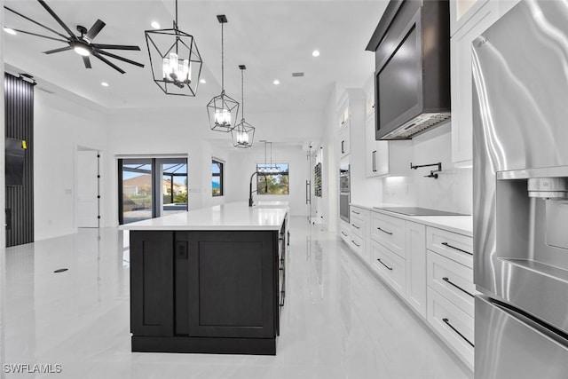 kitchen with a sink, decorative light fixtures, stainless steel appliances, white cabinets, and light countertops