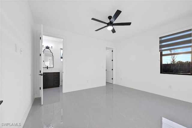 empty room featuring a ceiling fan and a sink