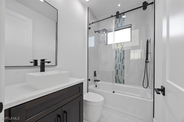 bathroom featuring enclosed tub / shower combo, toilet, and vanity