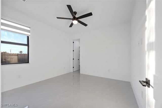 spare room with concrete floors and a ceiling fan