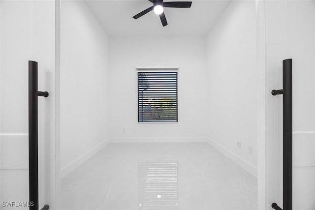 unfurnished room with baseboards and ceiling fan