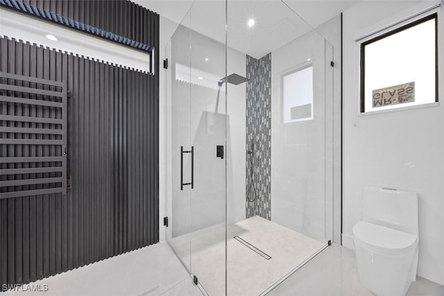 full bath featuring a stall shower and toilet