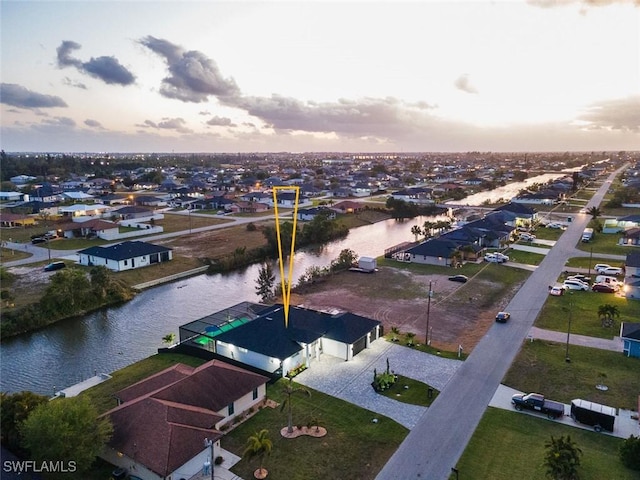 aerial view at dusk with a water view