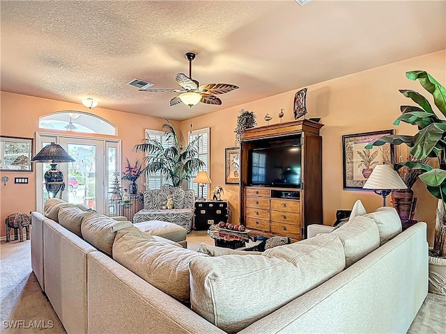 2030 Rio Nuevo Dr, North Fort Myers, FL 33917 - living room with light colored carpet, a ceiling fan, and a textured ceiling