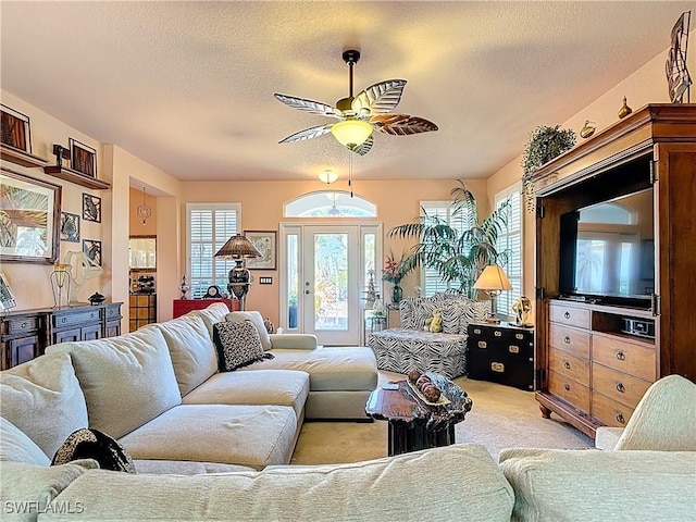 2030 Rio Nuevo Dr, North Fort Myers, FL 33917 - living area with ceiling fan, a textured ceiling, and light colored carpet