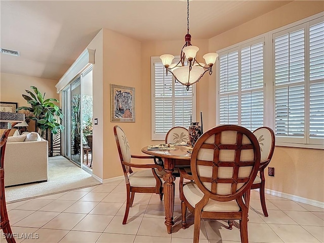 2030 Rio Nuevo Dr, North Fort Myers, FL 33917 - dining space featuring a chandelier, healthy amount of natural light, light tile patterned flooring, and baseboards